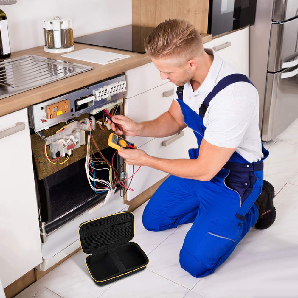 Appliance technician using a multimeter beside the open black and yellow carrying case