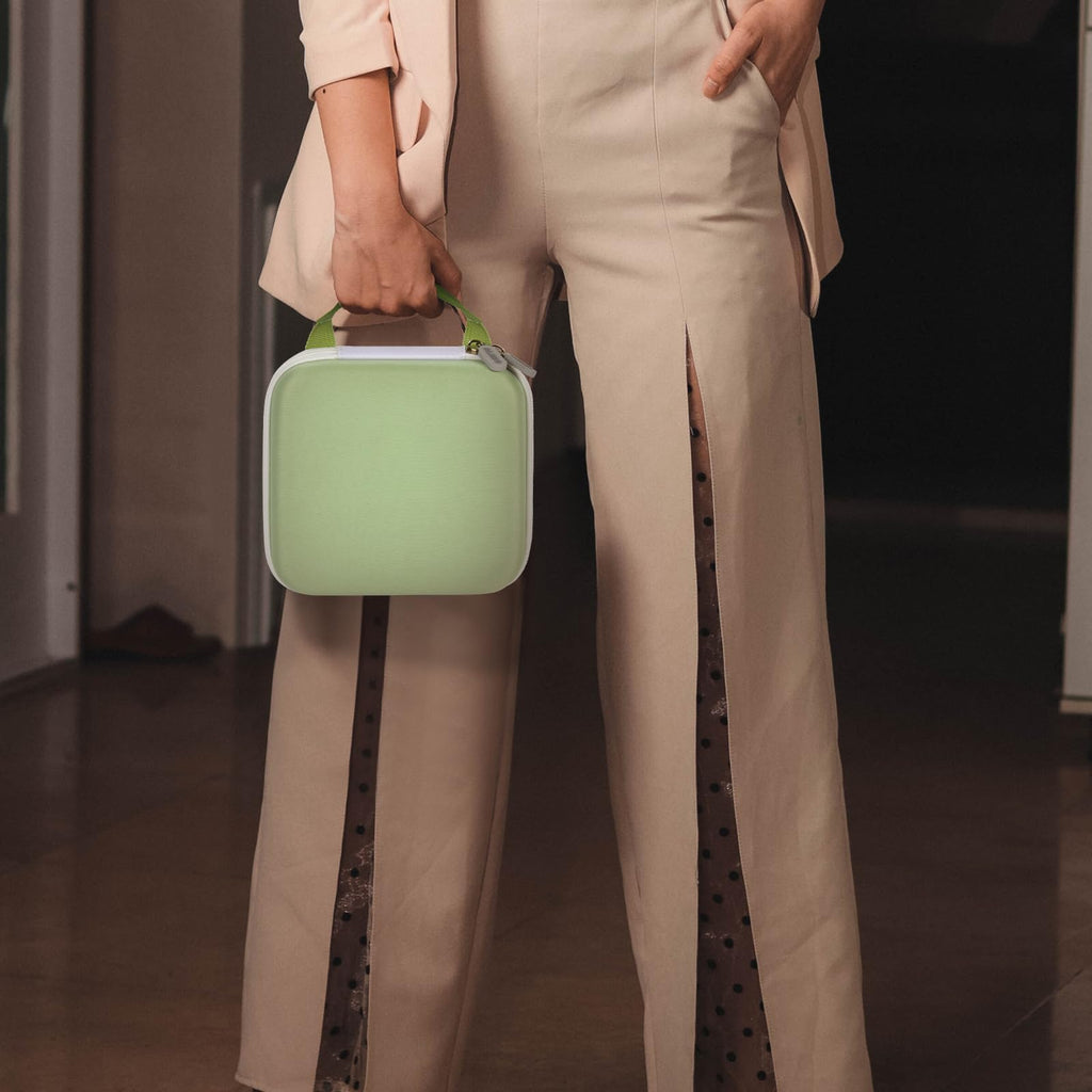 Person carrying the light green NIIMBOT label maker case by its top handle
