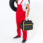 Worker carrying the black and yellow portable air compressor bag