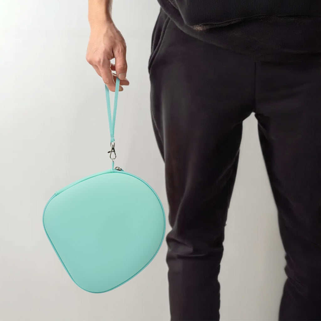 Person carrying the mint green headphone case by its wrist strap
