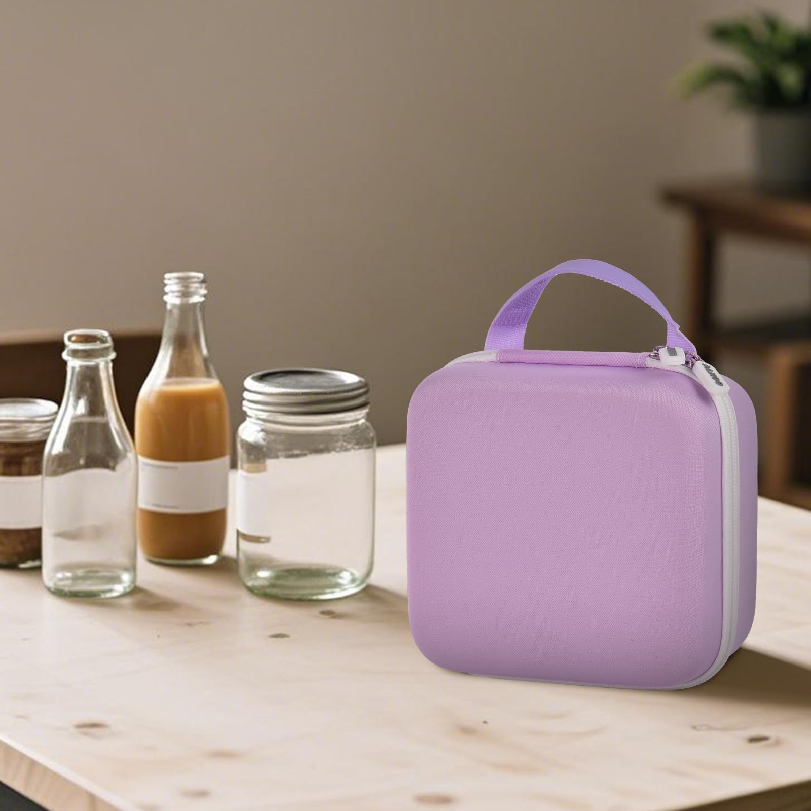 Open purple NIIMBOT label maker organizer beside bottles and jars