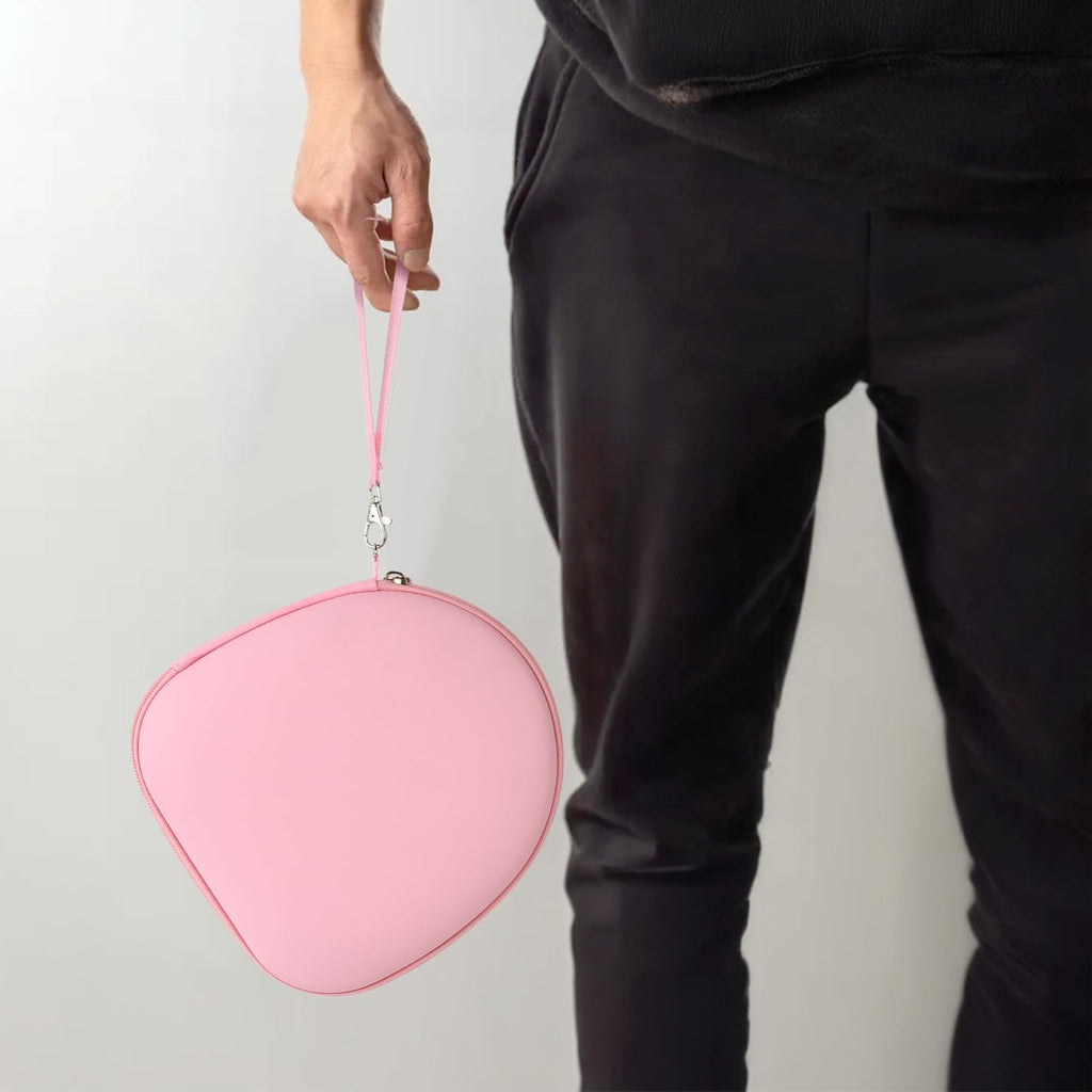 Person carrying the pink headphone case by its wrist strap