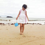 Blue kids instant print camera case open beside a child using the camera with a parent