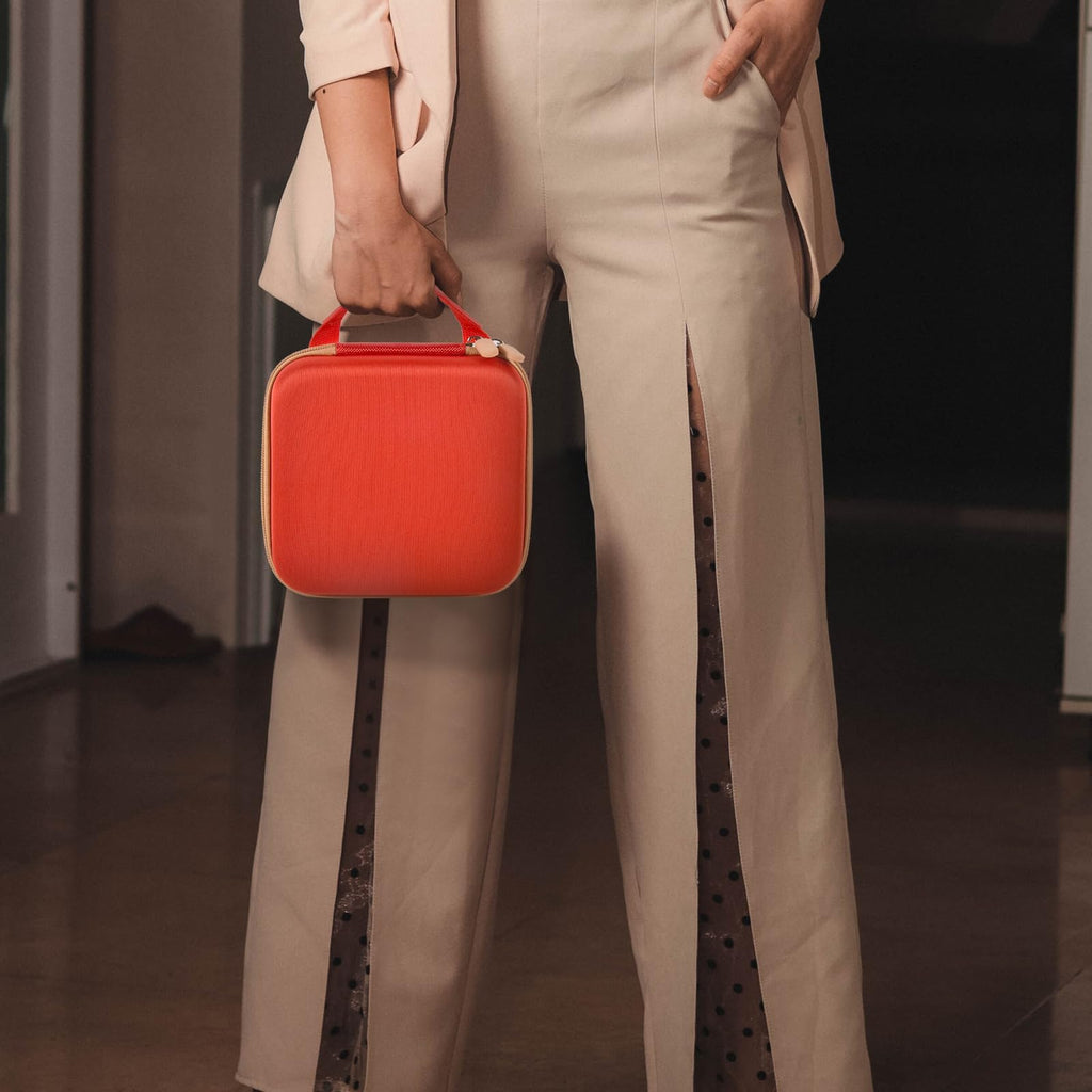 Person carrying the red NIIMBOT label maker case by its top handle