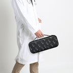 Healthcare professional carrying a closed black patterned hard stethoscope case