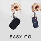 Black portable SSD case hanging from its carabiner for easy travel