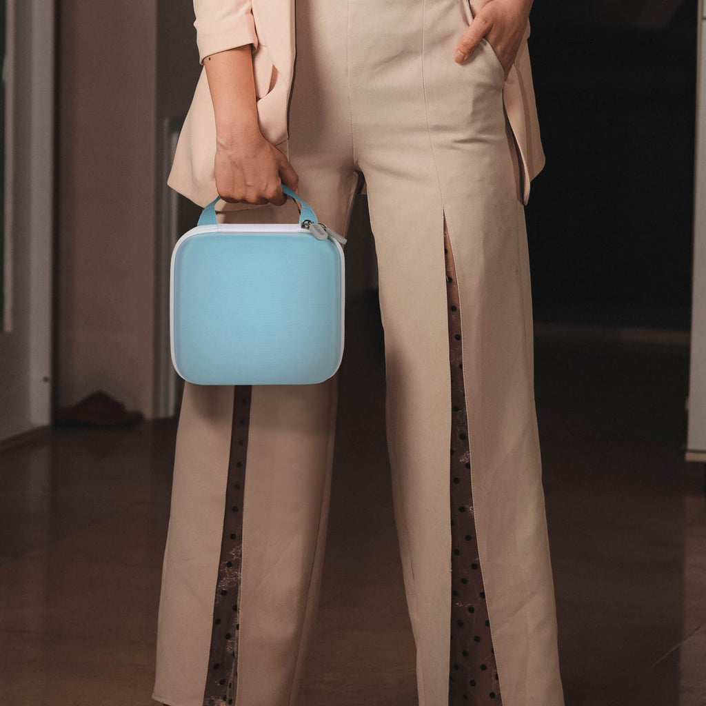 Person carrying the light blue NIIMBOT label maker case by its top handle