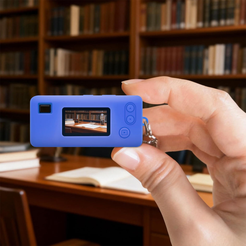 Blue with retro camera graphic silicone case for Kodak Charmera keychain camera shown on the camera while taking a photo indoors