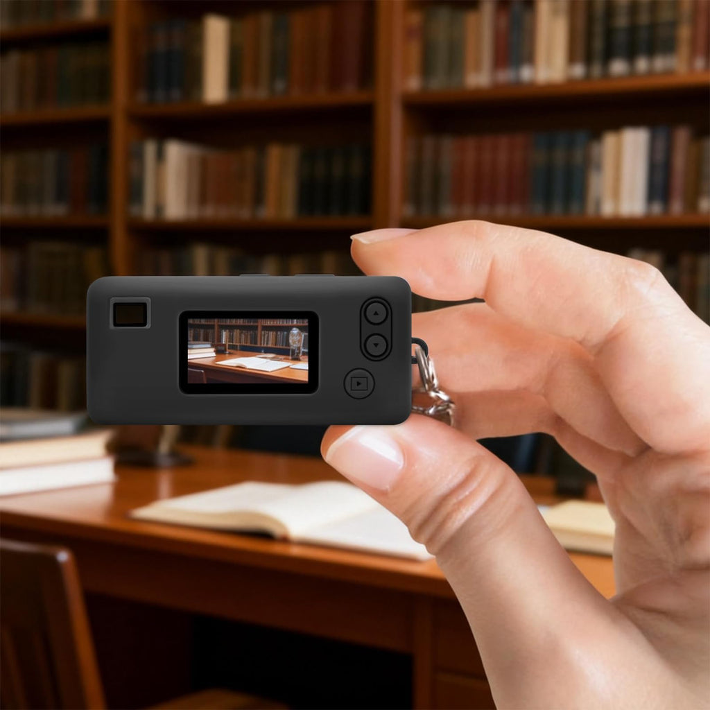 Black silicone case for Kodak Charmera keychain camera shown on the camera while taking a photo indoors