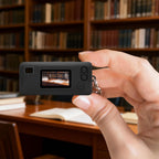 Black silicone case for Kodak Charmera keychain camera shown on the camera while taking a photo indoors