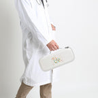 Healthcare professional carrying a closed white heart-patterned hard stethoscope case
