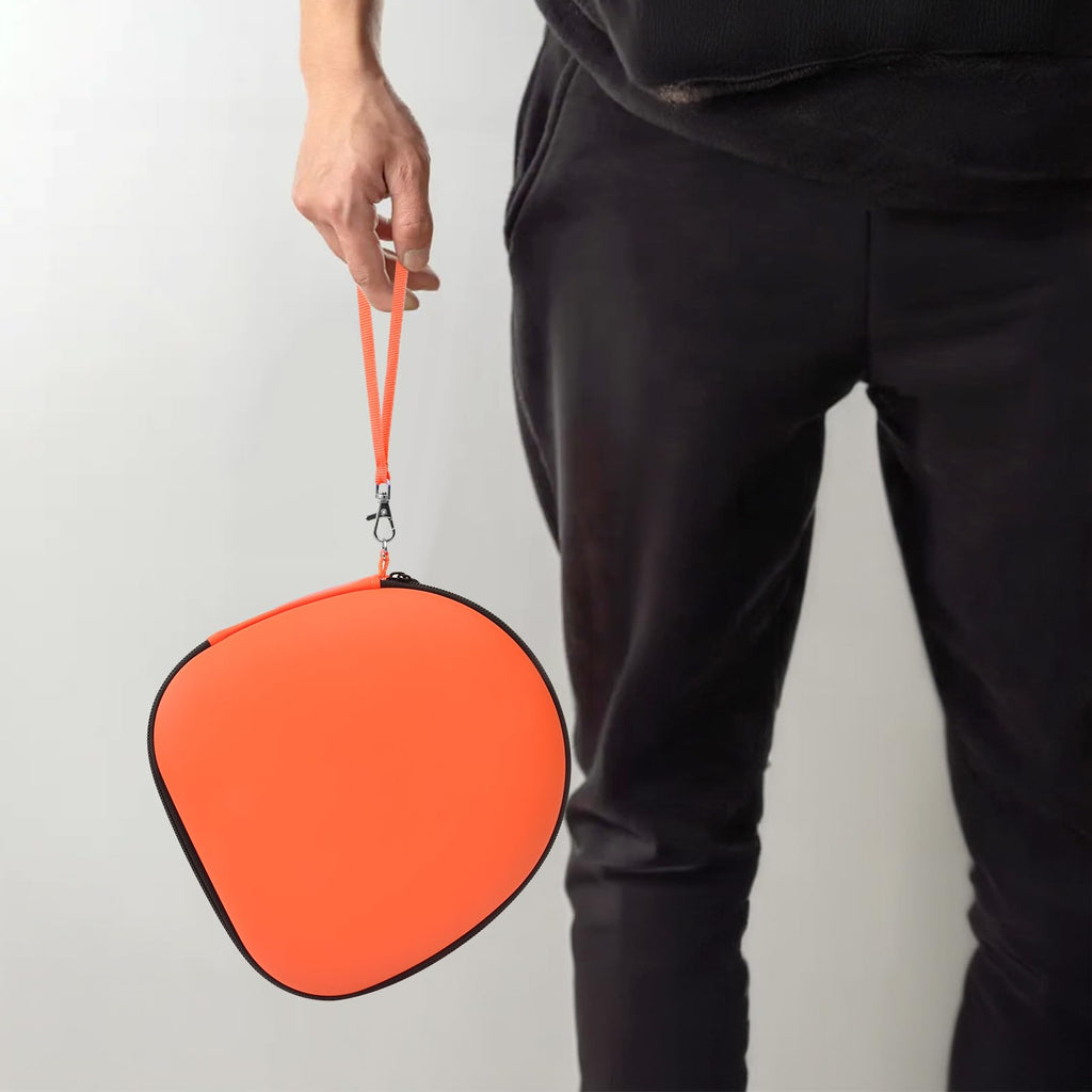 Person carrying the orange headphone case by its wrist strap