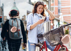 Rose gold headphone case attached to a backpack and carried by a traveler