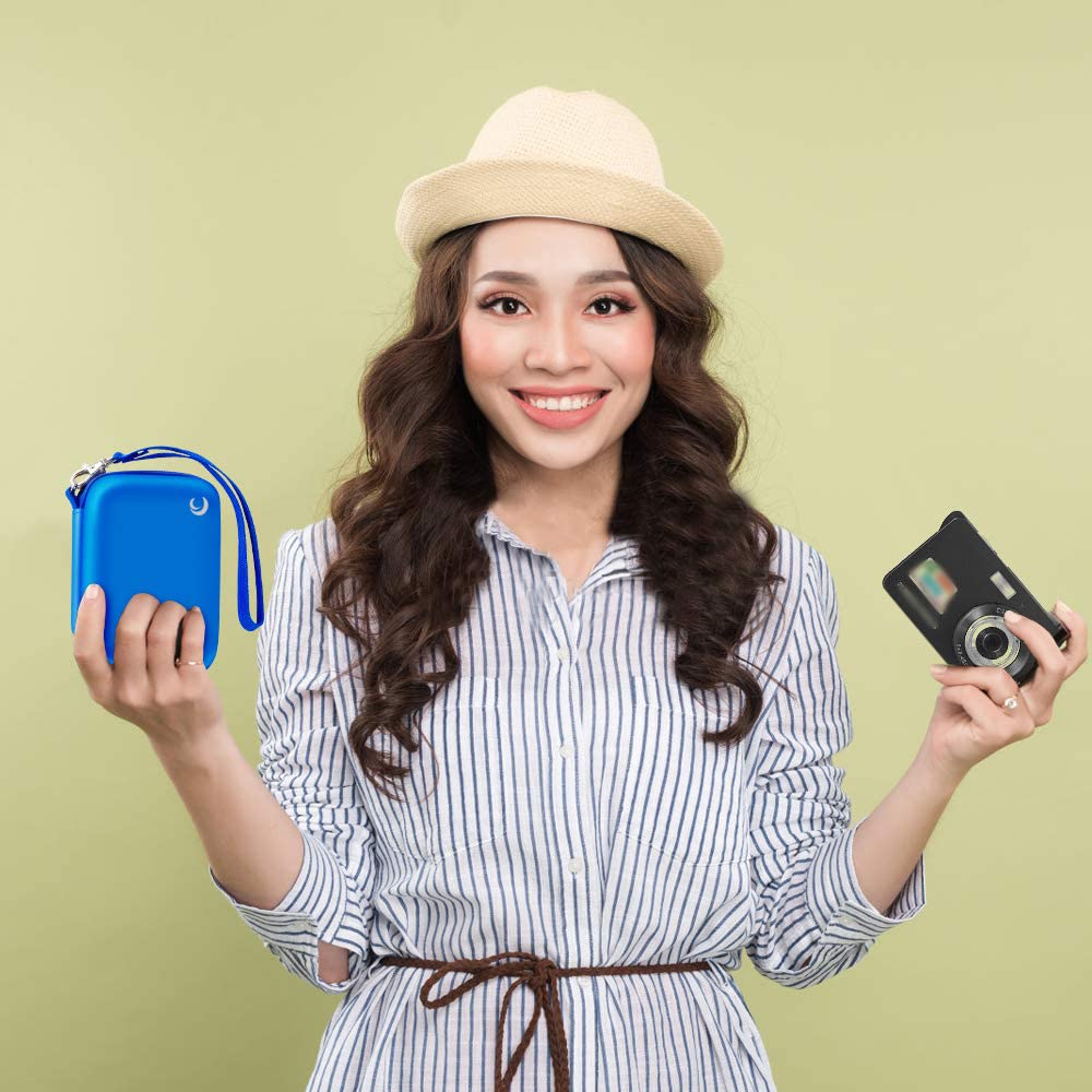Woman holding the blue camera case beside a compact digital camera