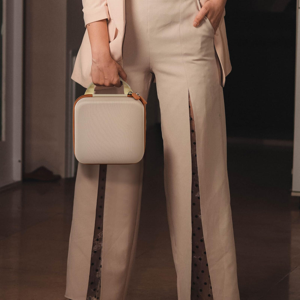 Person carrying the beige NIIMBOT label maker case by its top handle