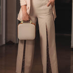 Person carrying the beige NIIMBOT label maker case by its top handle