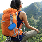 Blue music player case clipped to a hiking backpack