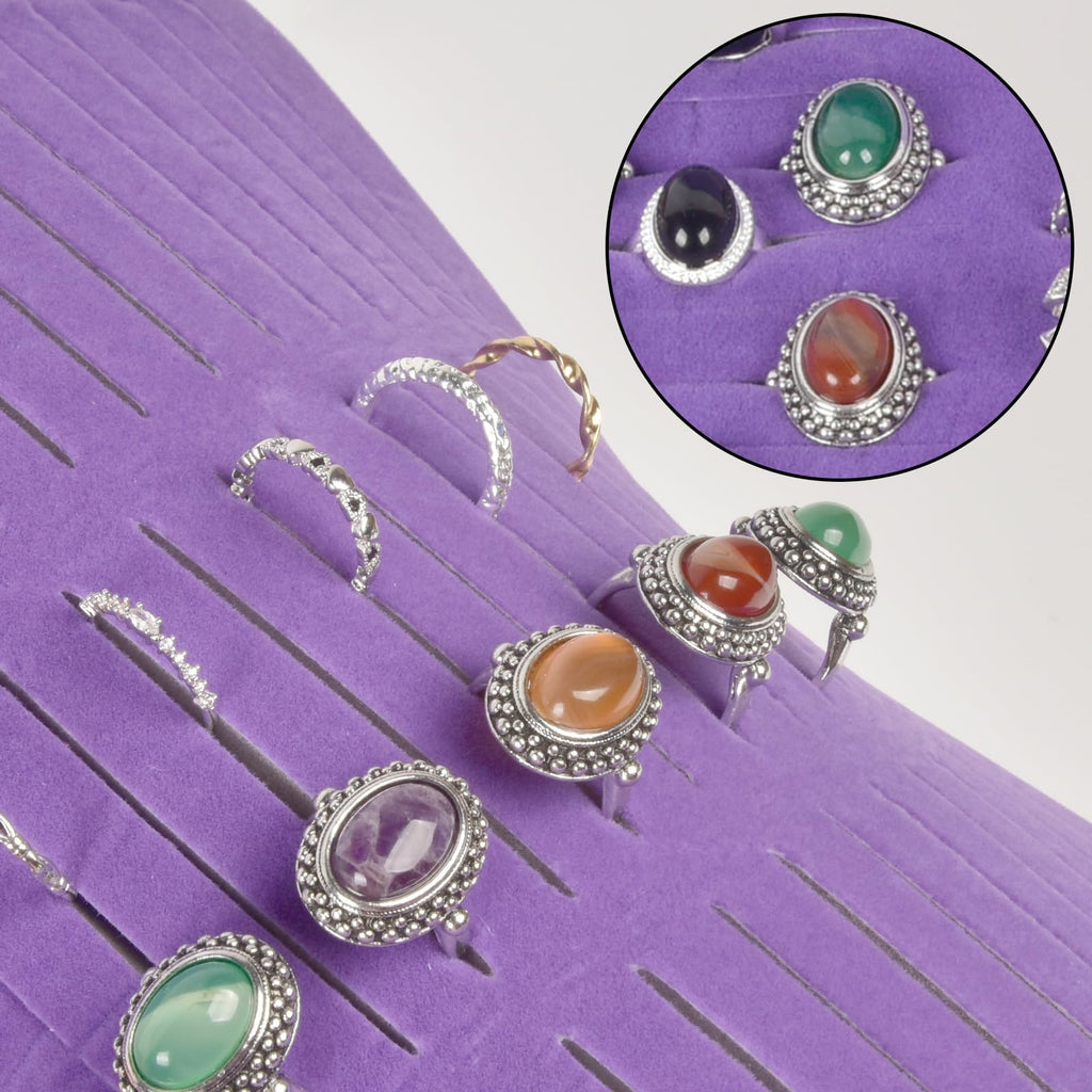 Rings and earrings displayed in the purple organizer's parallel jewelry slots