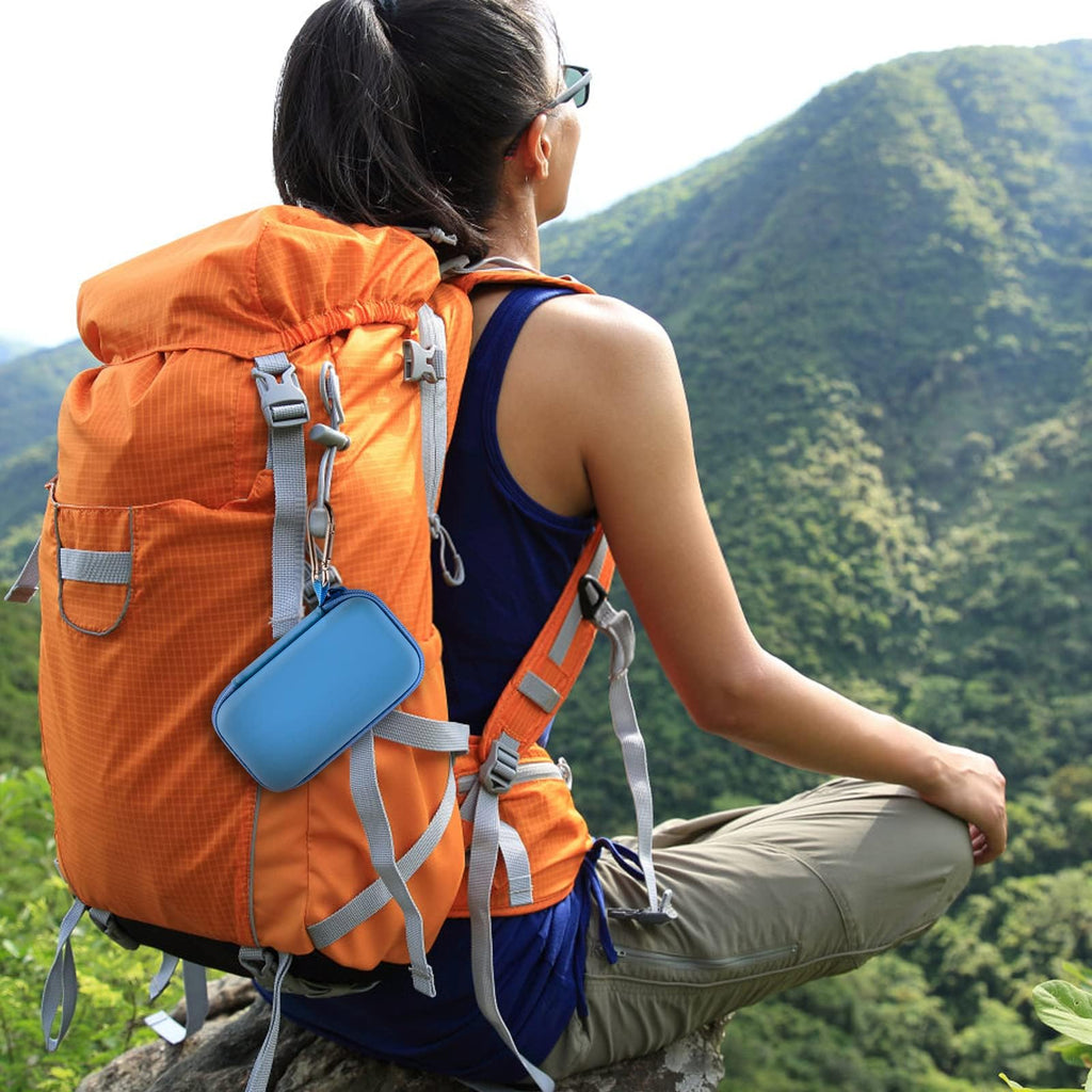 Bright blue music player case clipped to a hiking backpack
