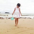 Mint green kids instant print camera case open beside a child using the camera with a parent