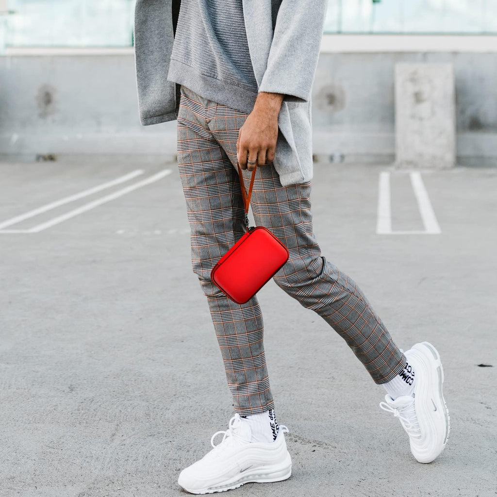 Person carrying the red charging station case by its wrist strap