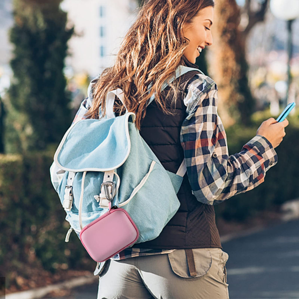Pink mini power bank case attached to a backpack for travel