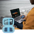 Open light blue SSD organizer beside a Crucial portable drive connected to a laptop