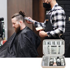 Barber using clippers beside an open beige grooming organizer case