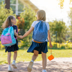 Orange protective digital camera case shown carried by children on an outdoor walk