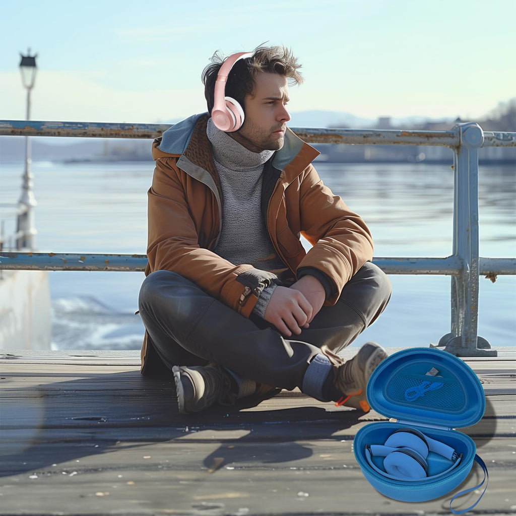 Man wearing headphones beside the open blue travel case at a waterfront