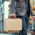 Person carrying the beige professional clipper case by its top handle