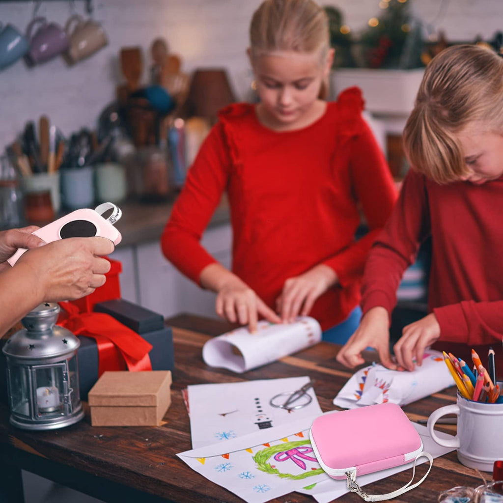 Children using a mini label printer beside the pink carrying case