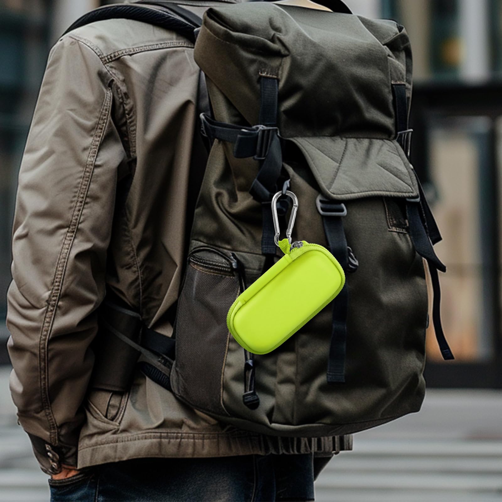 Neon green USB flash drive and SD card storage case clipped to a backpack