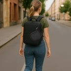 Black headphone case attached to the outside of a backpack for travel