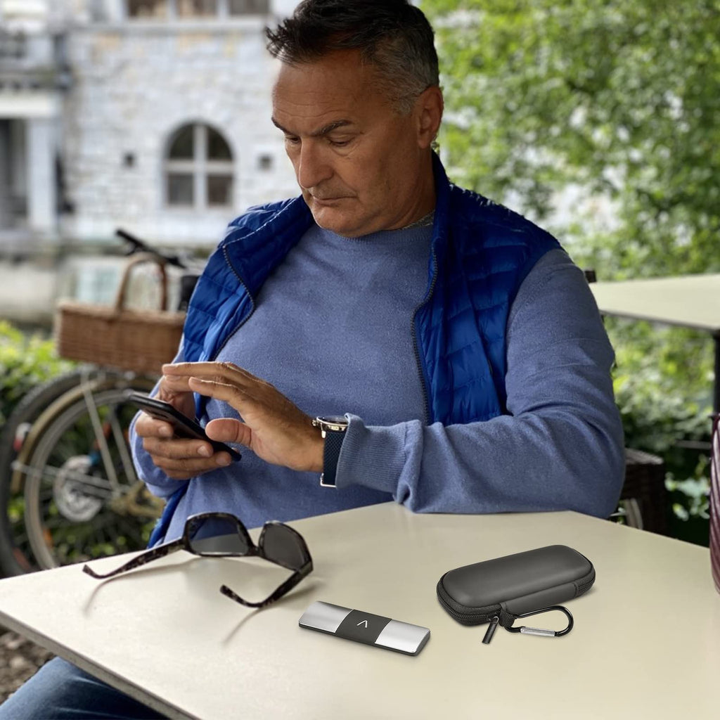 Man using a KardiaMobile device beside the open black travel case