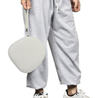 Traveler using headphones beside the open light gray carrying case on an airplane