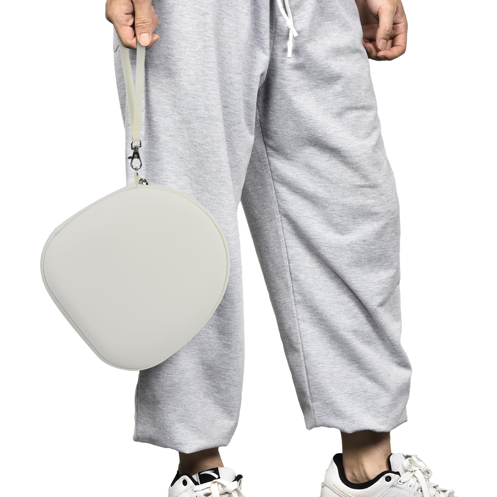 Traveler using headphones beside the open light gray carrying case on an airplane