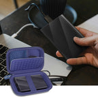 Blue portable SSD case organizing an external drive beside a laptop