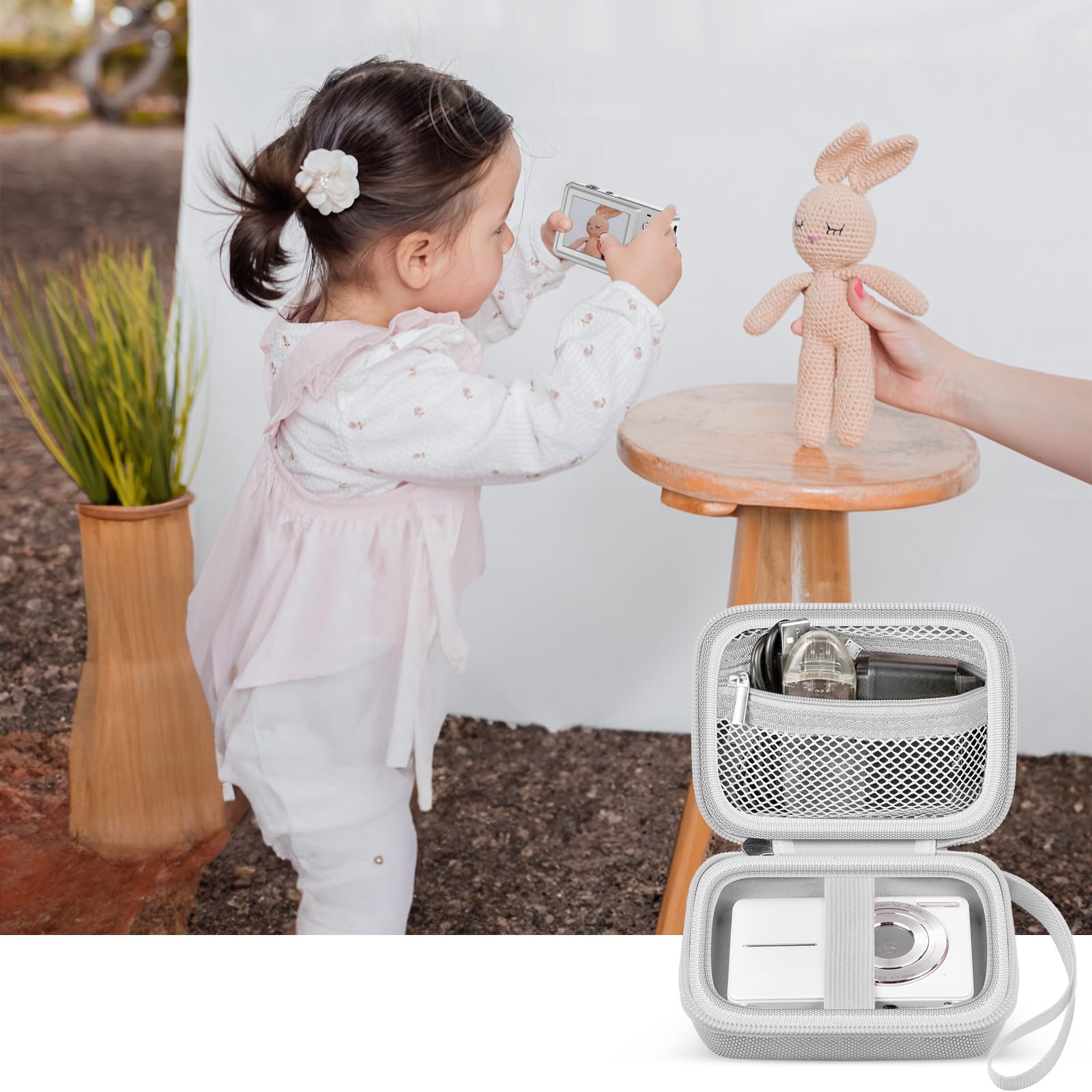 White protective digital camera case shown beside a child using a compact camera