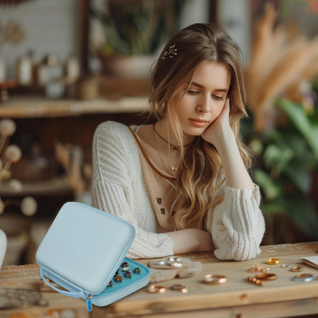 Woman using the blue ring organizer on a jewelry worktable