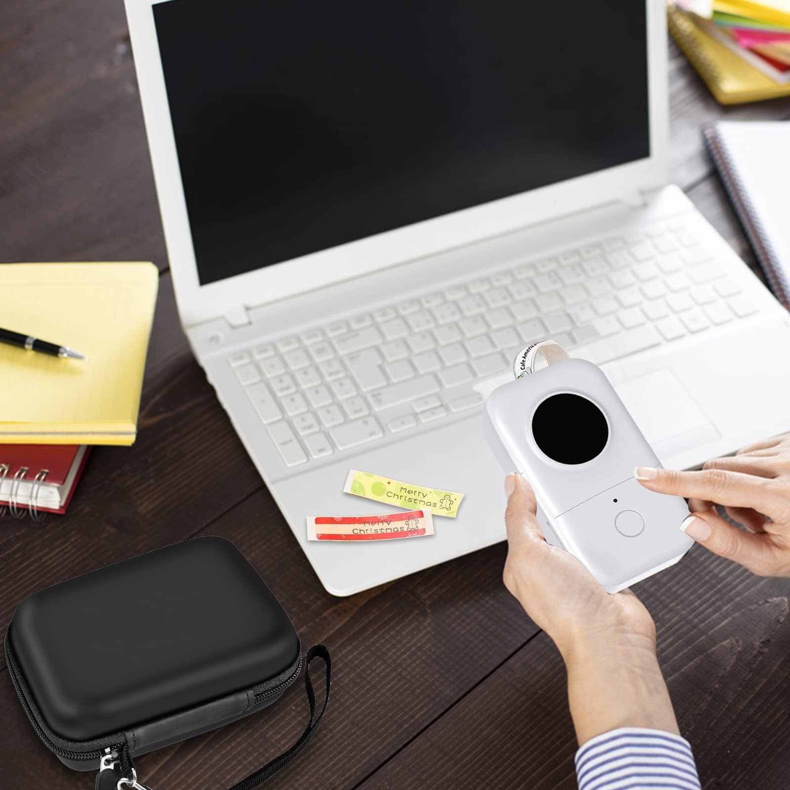 Black mini printer case beside a laptop during label-making work