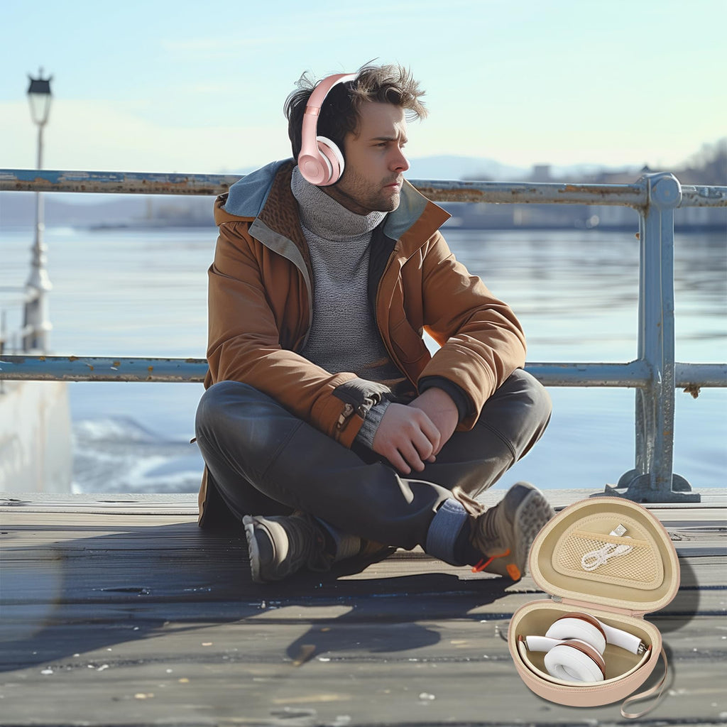 Man wearing headphones beside the open beige travel case at a waterfront