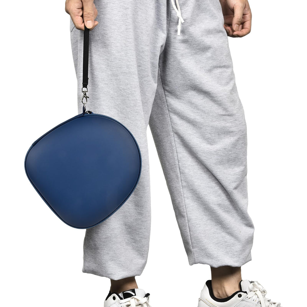 Person carrying the navy blue headphone case by its wrist strap