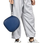 Person carrying the navy blue headphone case by its wrist strap
