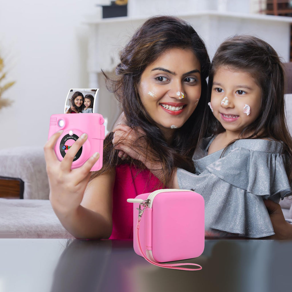 Pink kids instant print camera case open beside a child using the camera with a parent