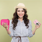 Woman holding the magenta camera case beside a compact digital camera
