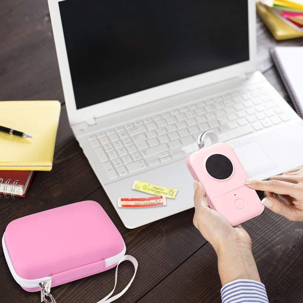 Pink mini printer case beside a laptop during label-making work