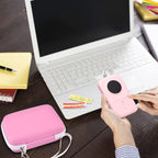 Pink mini printer case beside a laptop during label-making work