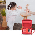 Red protective digital camera case shown beside a child using a compact camera