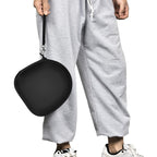 Person carrying the black headphone case by its wrist strap
